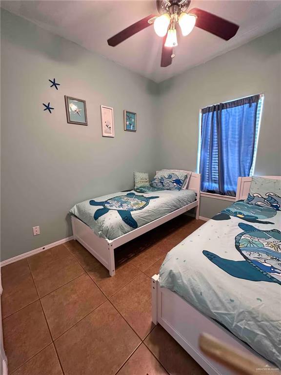 bedroom featuring ceiling fan and tile patterned flooring