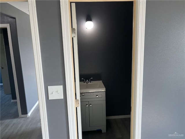 121 N Kentucky St, Mission, TX 78573 - bathroom featuring vanity, baseboards, and wood finished floors