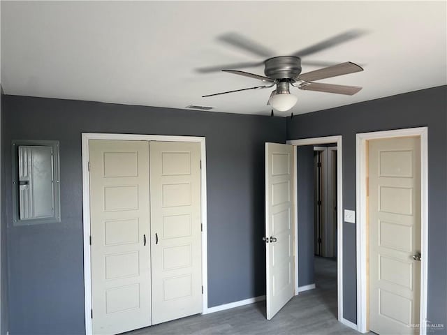 121 N Kentucky St, Mission, TX 78573 - unfurnished bedroom featuring wood finished floors, a closet, baseboards, and ceiling fan