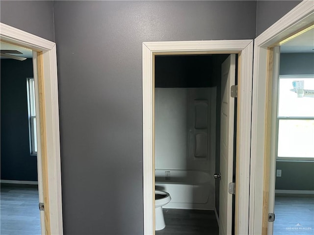 121 N Kentucky St, Mission, TX 78573 - corridor featuring wood finished floors, baseboards, and healthy amount of natural light