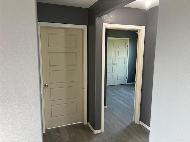 121 N Kentucky St, Mission, TX 78573 - hallway featuring dark wood-type flooring and baseboards