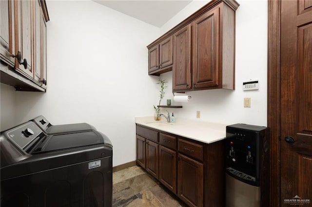 clothes washing area with cabinets, separate washer and dryer, and sink