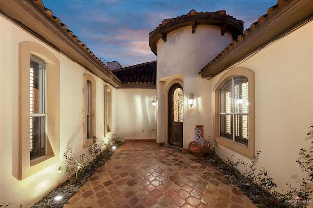 exterior entry at dusk with a patio