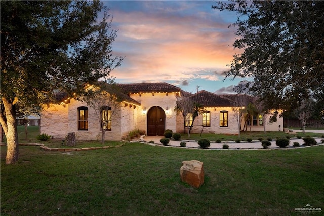 mediterranean / spanish-style house featuring a lawn