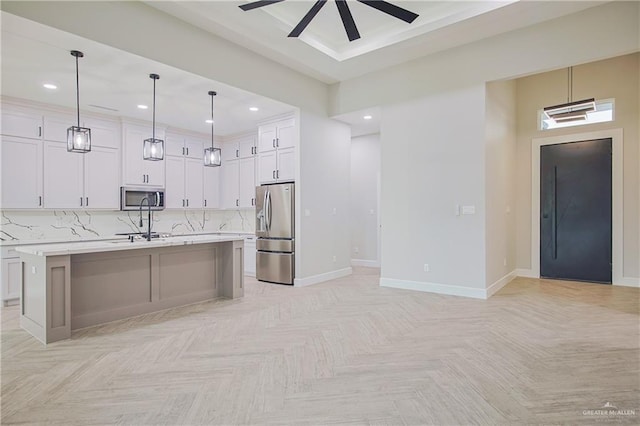 kitchen featuring light countertops, appliances with stainless steel finishes, backsplash, and white cabinetry