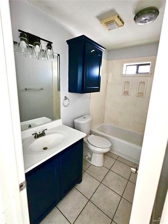 1417 Prosperity Dr, Edinburg, TX 78541 - full bath with a tub to relax in, vanity, toilet, and tile patterned floors