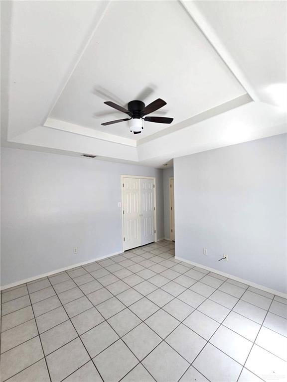1417 Prosperity Dr, Edinburg, TX 78541 - unfurnished room featuring baseboards, visible vents, a raised ceiling, and a ceiling fan