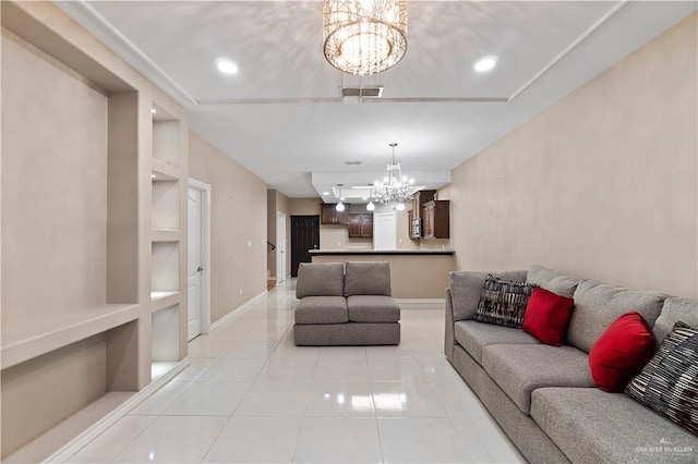 living room featuring built in features, light tile patterned floors, and an inviting chandelier