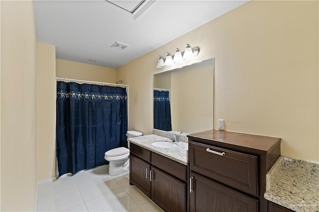 bathroom featuring tile patterned flooring, vanity, toilet, and walk in shower