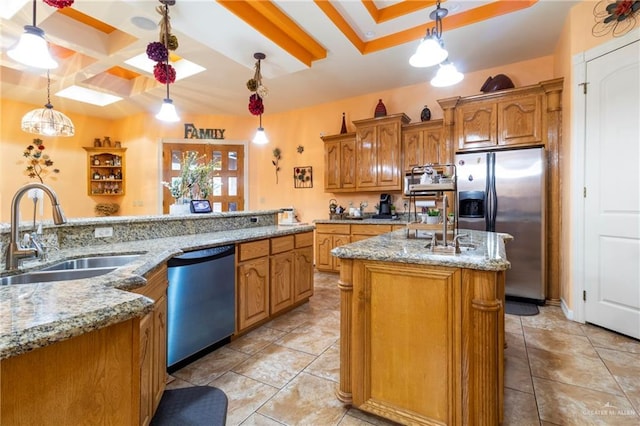 kitchen with decorative light fixtures, black dishwasher, sink, stainless steel fridge, and a kitchen island with sink