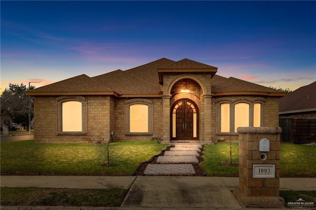 1003 N 40th Ln, Mcallen, TX 78501 - view of front of property featuring french doors and a yard