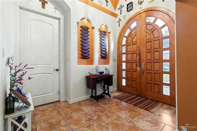 foyer entrance with light tile patterned floors