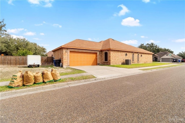 view of front of property featuring a garage and cooling unit