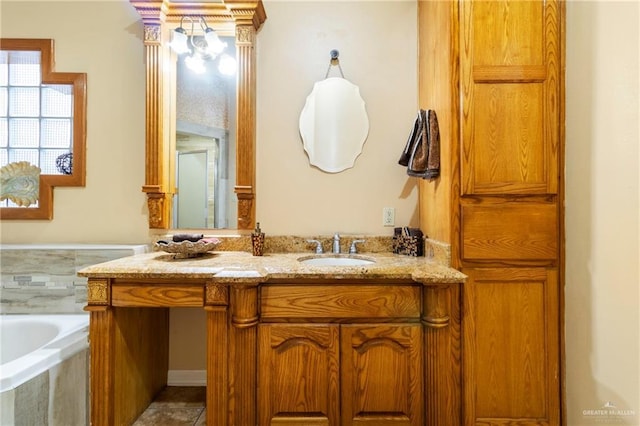 bathroom with vanity and a relaxing tiled tub