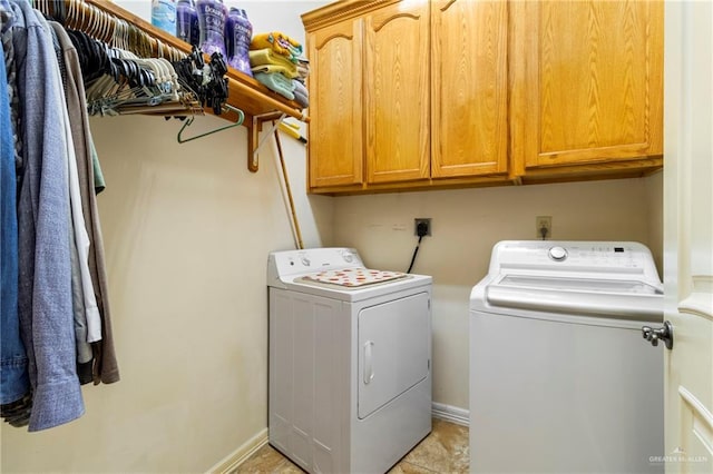 laundry area with cabinets and washer and clothes dryer