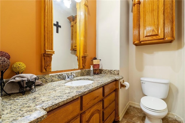 bathroom with vanity, toilet, and tile patterned flooring