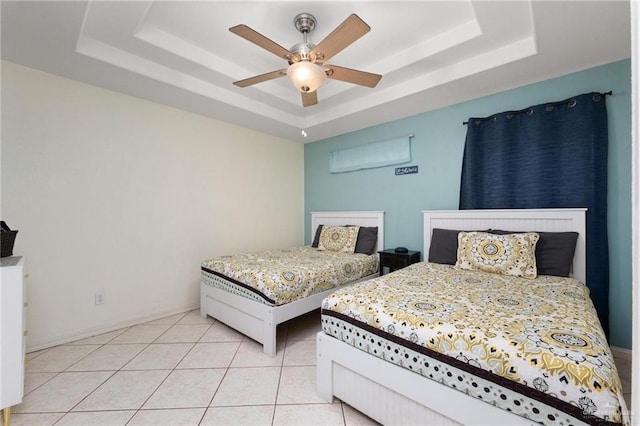 103 W Dolphin St Unit 1B, South Padre Island, TX 78597 - bedroom with light tile patterned floors, ceiling fan, a raised ceiling, and baseboards