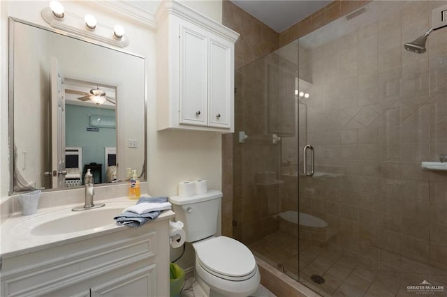 103 W Dolphin St Unit 1B, South Padre Island, TX 78597 - bathroom with toilet, a stall shower, ceiling fan, and vanity