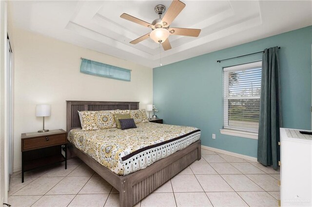 103 W Dolphin St Unit 1B, South Padre Island, TX 78597 - bedroom with a raised ceiling, baseboards, and light tile patterned floors