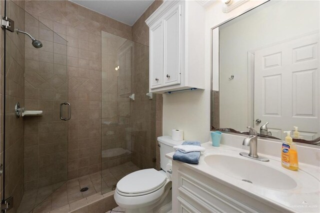 103 W Dolphin St Unit 1B, South Padre Island, TX 78597 - full bath with a stall shower, vanity, and toilet
