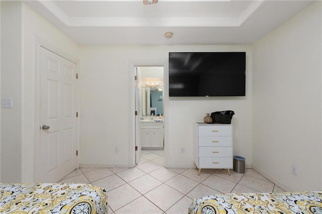 103 W Dolphin St Unit 1B, South Padre Island, TX 78597 - unfurnished bedroom with ensuite bath, baseboards, and light tile patterned flooring