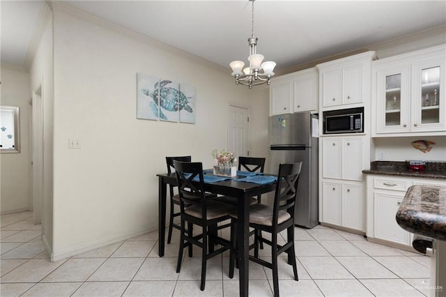 103 W Dolphin St Unit 1B, South Padre Island, TX 78597 - dining room featuring a chandelier, light tile patterned flooring, and crown molding