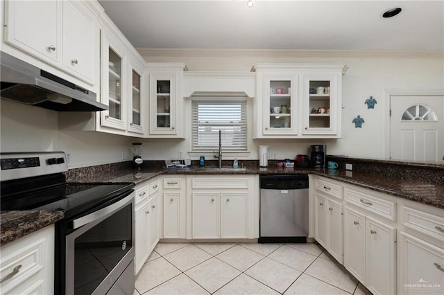 103 W Dolphin St Unit 1B, South Padre Island, TX 78597 - kitchen featuring light tile patterned floors, appliances with stainless steel finishes, ornamental molding, a sink, and under cabinet range hood