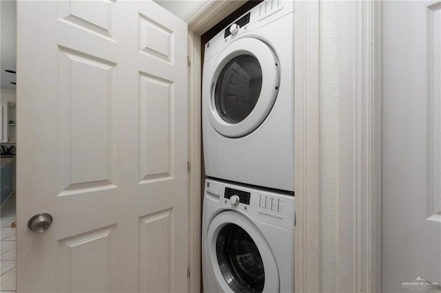 103 W Dolphin St Unit 1B, South Padre Island, TX 78597 - clothes washing area featuring stacked washer and dryer and laundry area
