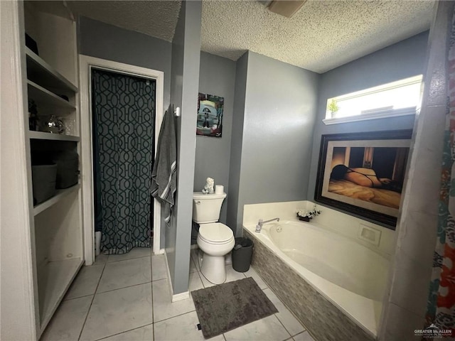 bathroom with tile patterned floors, a garden tub, toilet, and a textured ceiling