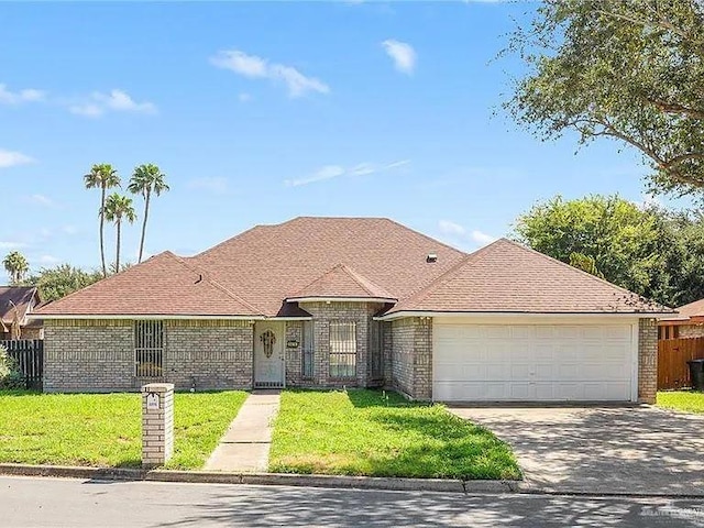 ranch-style home with a garage, driveway, brick siding, and a front lawn