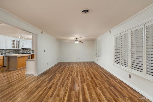 unfurnished living room featuring hardwood / wood-style floors, ceiling fan, and crown molding