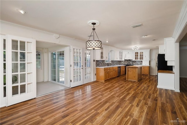 kitchen with dishwasher, a center island, sink, hanging light fixtures, and tasteful backsplash