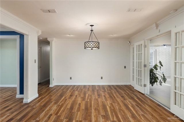 unfurnished dining area featuring french doors, dark hardwood / wood-style floors, and ornamental molding