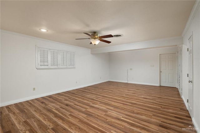 spare room featuring ceiling fan, dark wood-type flooring, and ornamental molding