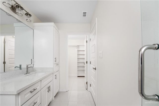 bathroom with tile patterned flooring and vanity