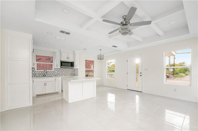 interior space featuring a wealth of natural light, light tile patterned floors, coffered ceiling, and ceiling fan