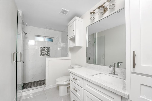 bathroom featuring toilet, vanity, tile patterned floors, and walk in shower