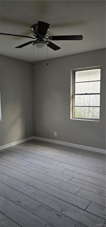 unfurnished room featuring ceiling fan and light wood-type flooring