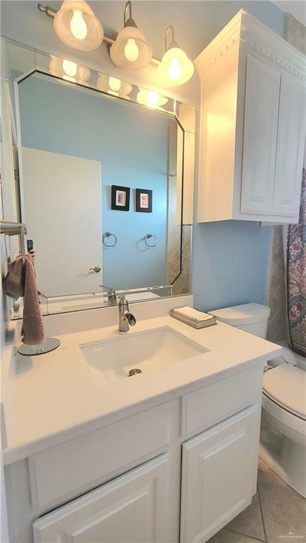 bathroom featuring toilet, vanity, and tile patterned floors