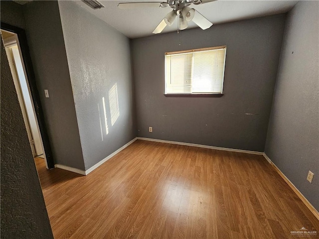 unfurnished room with ceiling fan and hardwood / wood-style floors