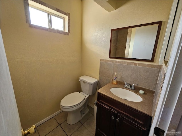 bathroom with vanity, backsplash, tile patterned floors, and toilet