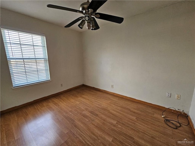 empty room featuring ceiling fan and hardwood / wood-style floors