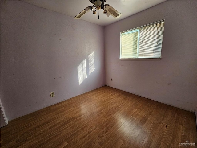 empty room featuring hardwood / wood-style flooring and ceiling fan