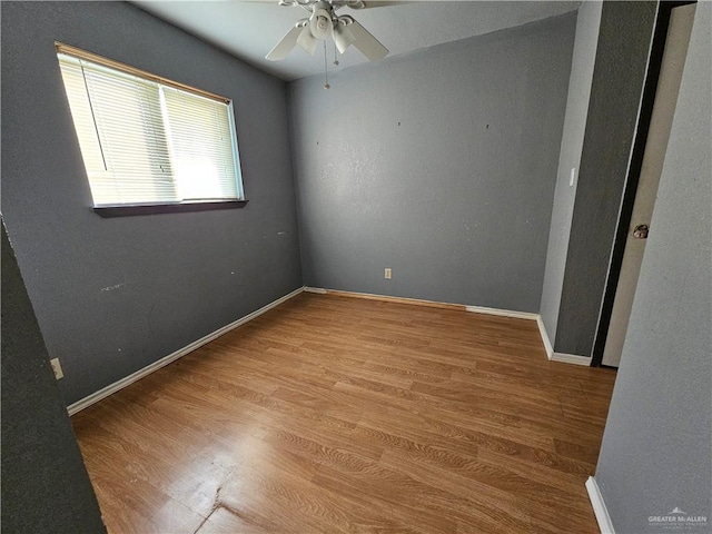 spare room with ceiling fan and light wood-type flooring