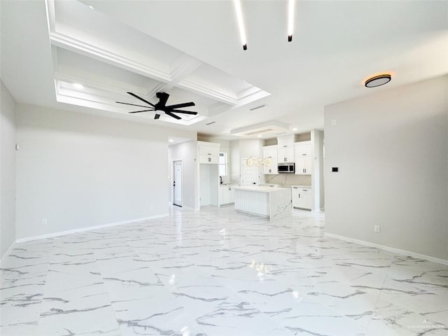 unfurnished living room featuring coffered ceiling, beam ceiling, and ceiling fan