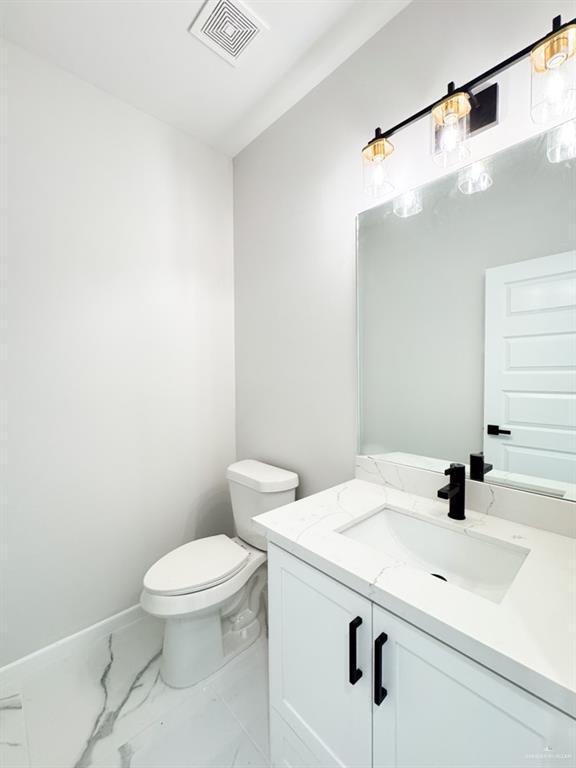 bathroom featuring vanity and toilet