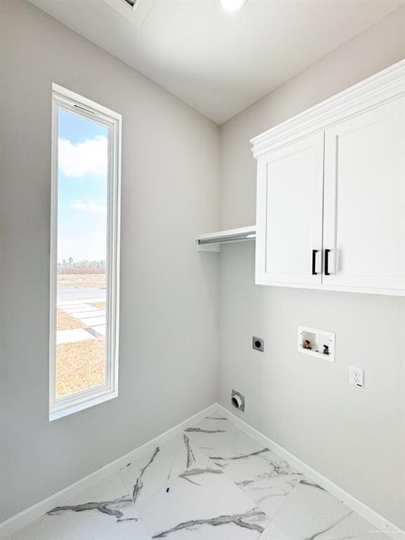 clothes washing area featuring cabinets, plenty of natural light, hookup for an electric dryer, and hookup for a washing machine