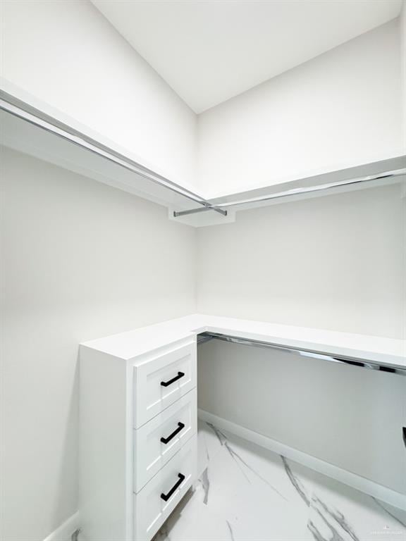 walk in closet featuring built in desk