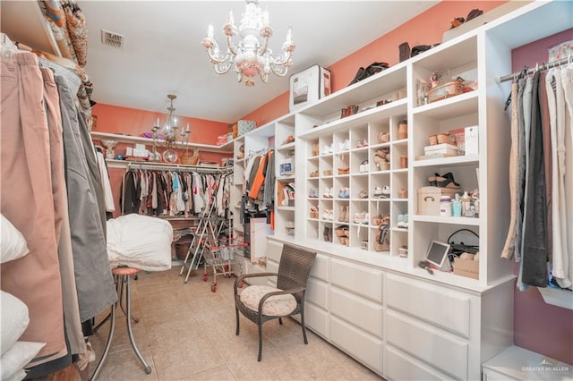 spacious closet with a notable chandelier and visible vents