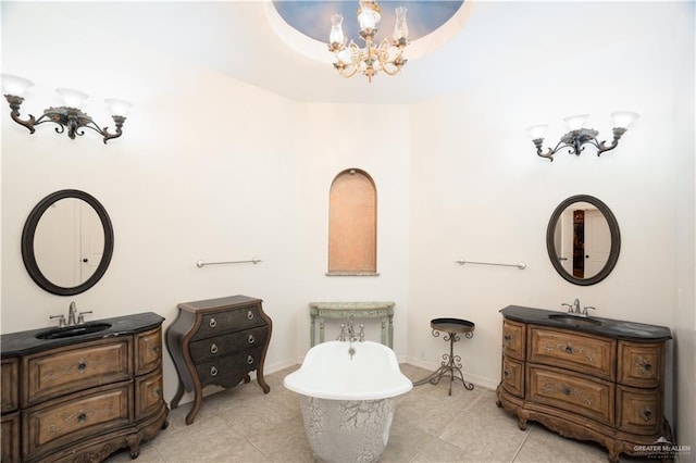 bathroom with a sink, two vanities, and a notable chandelier